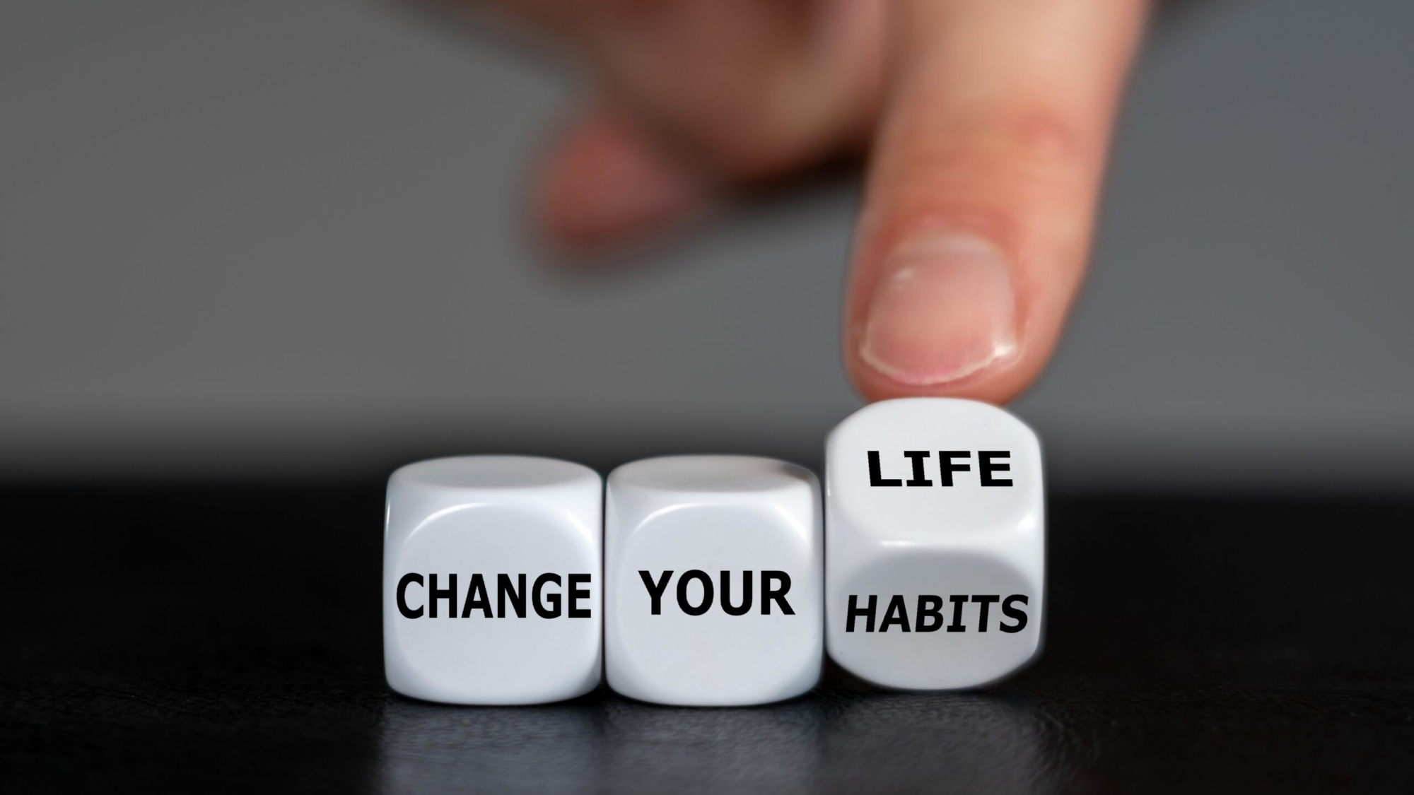 Hand,Turns,Dice,And,Changes,The,Slogan,'change,Your,Habits'
